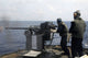 Gunner firing Mark 38 machine gun aboard USS Frank Cable poster print.
