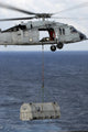MH-60S Sea Hawk helicopter conducting vertical replenishment at sea poster print