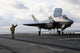 Aviation Boatswain's Mate signaling F-35B Lightning II off flight deck poster print.