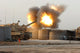 Soldiers firing howitzers on M109A6 Paladins poster print.