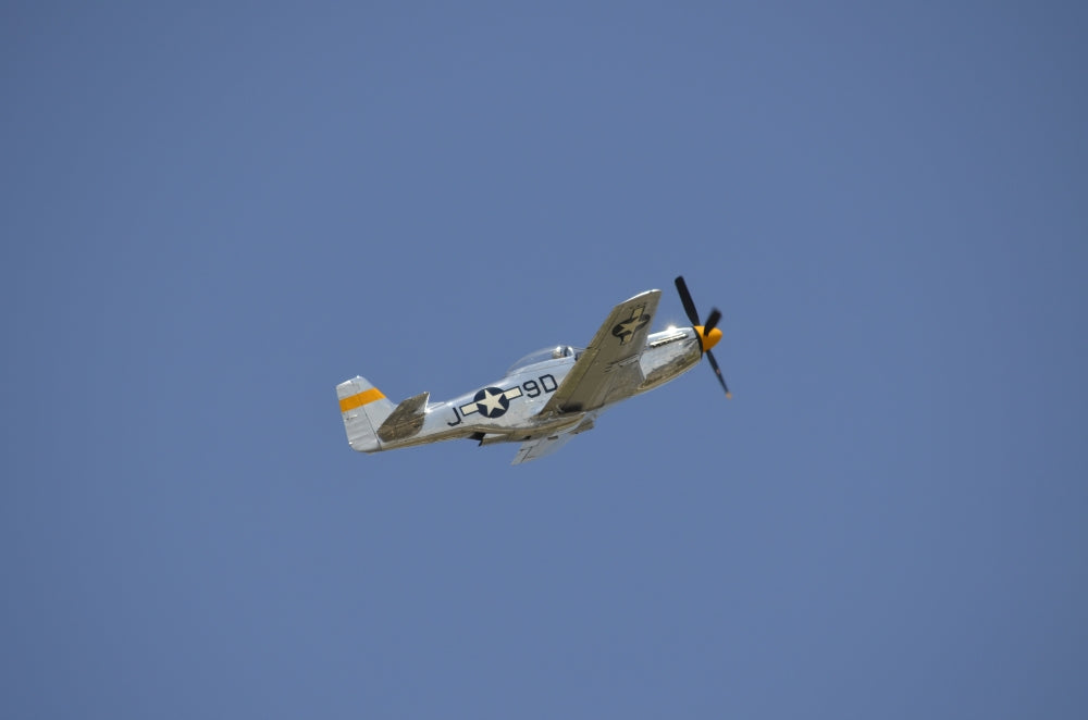 P-51 Mustang in flight poster print showcasing aviation art.
