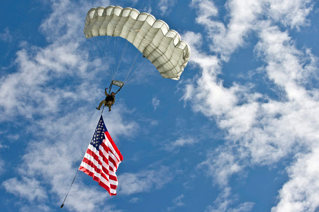 US Air Force member gliding through the sky with American flag poster print