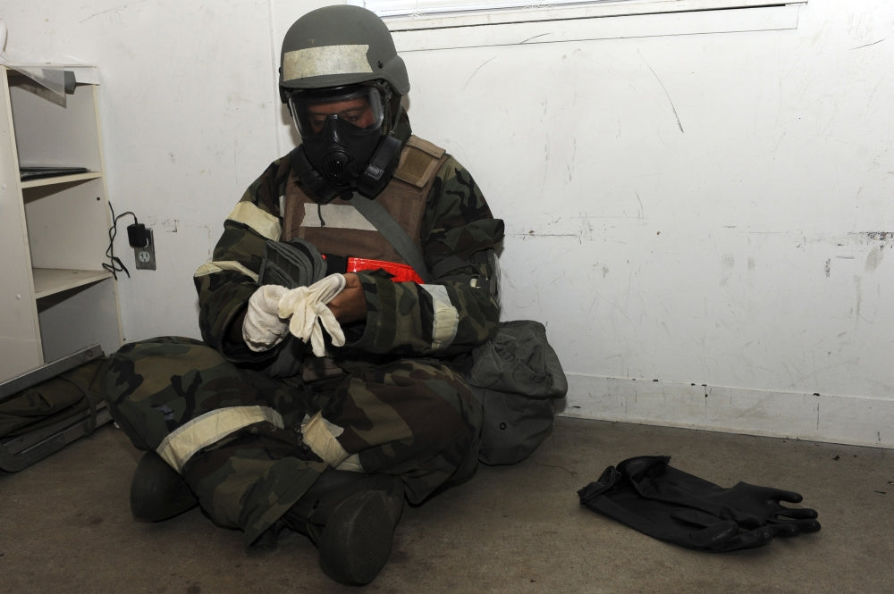 Senior Airman in chemical warfare defense ensemble at Little Rock Air Force Base poster print.