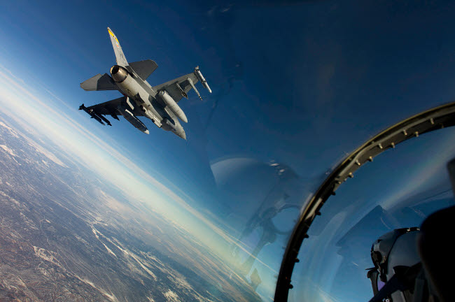 F-16 Fighting Falcon flying above wingman poster print by Stocktrek Images.