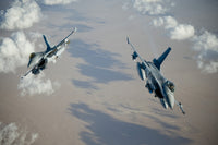 F-16A Falcons performing a split break maneuver over Afghanistan poster print.