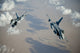 F-16A Falcons performing a split break maneuver over Afghanistan poster print.