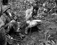 An officer receives a report on a field radio in the battlefield poster print