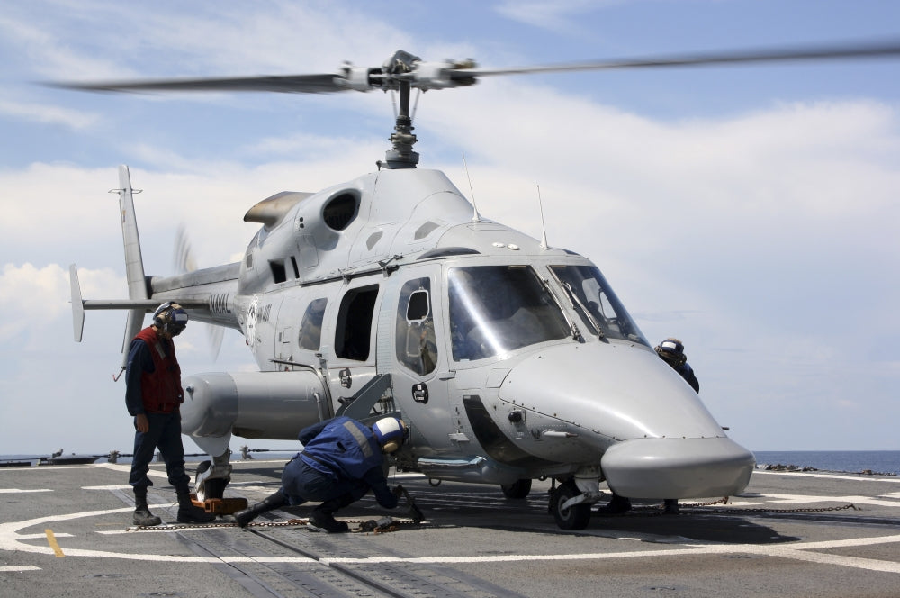 U.S. Sailors chock and chain an Ecuadorian Navy Bell 230 helicopter poster print.