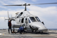 U.S. Sailors chock and chain an Ecuadorian Navy Bell 230 helicopter poster print.