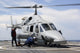U.S. Sailors chock and chain an Ecuadorian Navy Bell 230 helicopter poster print.