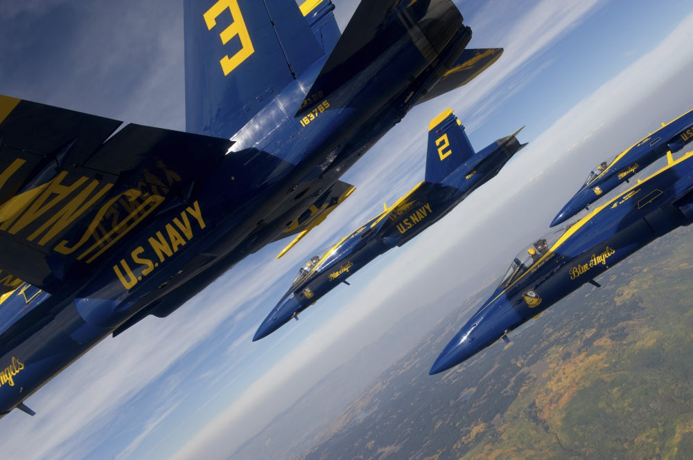 F/A-18 Hornets of the Blue Angels flying in formation over Colorado.
