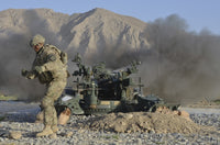 U.S. Army soldier firing M777 howitzer at Forward Operating Base Al Masaak Poster Print