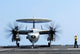 Aviation Boatswain's Mate directing an E-2C Hawkeye on the flight deck poster print.