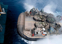 Landing craft air cushion entering USS Iwo Jima well deck poster print.