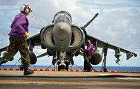 Aviation boatswain's mates refueling an AV-8B Harrier jet poster print.