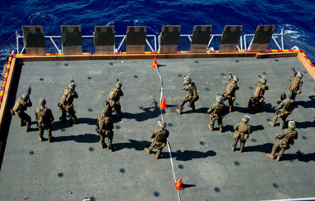 Marines firing rounds at targets aboard USS Bonhomme Richard poster print.