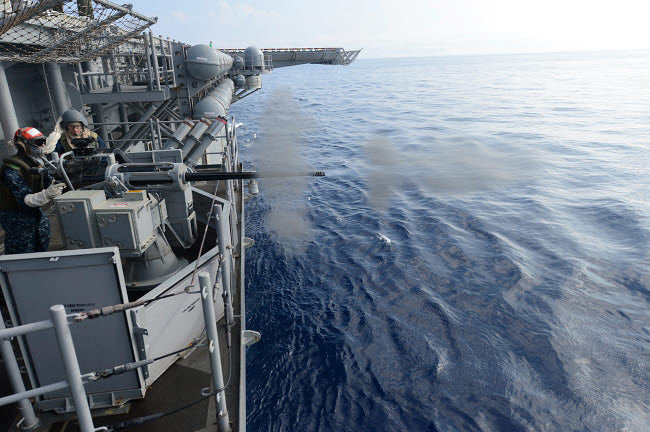 Sailors firing a 25mm machine gun aboard USS Bonhomme Richard poster print.
