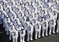 Sailors bow their heads in prayer at a memorial service poster print