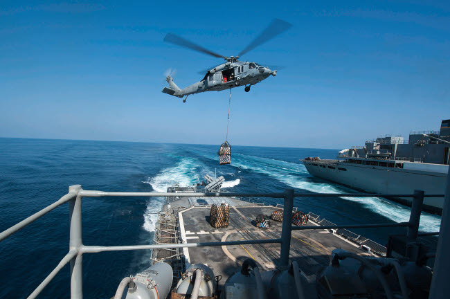 MH-60S Sea Hawk delivering supplies to USS Mobile Bay Poster Print