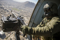 Czech Air Force door gunner scanning for threats from Mil Mi-17 helicopter in Afghanistan.