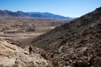 US Marine climbs a hill to conduct a site survey in Afghanistan poster print.