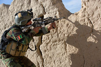 Afghan Commando keeps watch for insurgents during a security operation poster print.