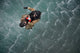 Water rescue training scenario poster print featuring airmen being hoisted out of the water.