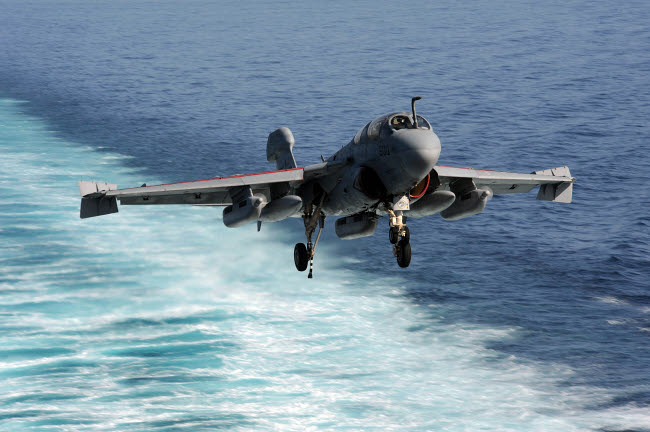 EA-6B Prowler landing on USS John C. Stennis aircraft carrier poster print.