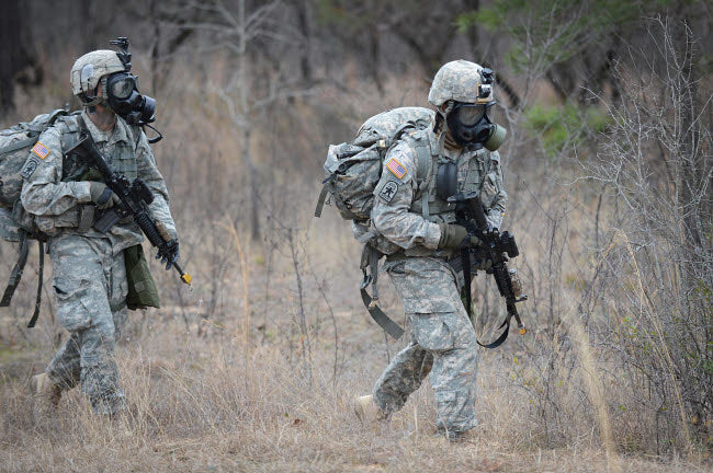 US soldiers in chemical warfare gear poster print by Stocktrek Images