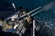 Seaman firing twin .50 caliber machine guns during a live-fire exercise aboard USS Boxer, Pacific Ocean.