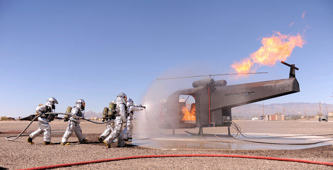 US Air Force Airmen extinguish a simulated aircraft fire poster print.
