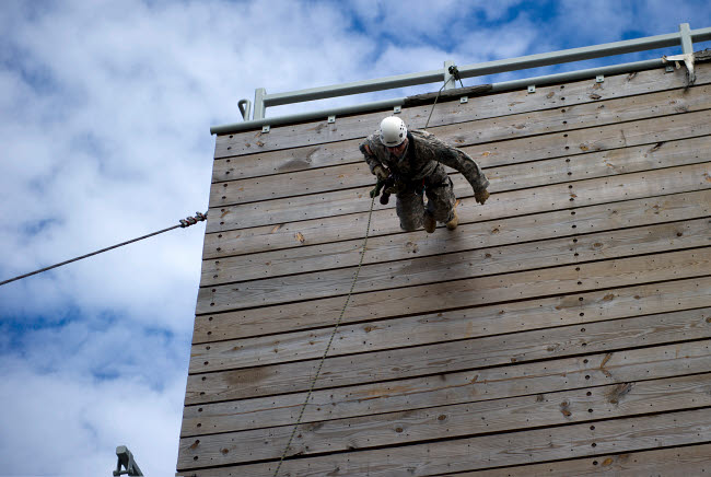 US Soldier running down a 40-foot rappelling wall poster print.