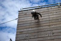 US Soldier running down a 40-foot rappelling wall poster print.