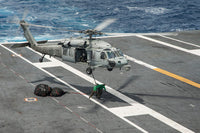 Sailors connecting cargo legs and nets to an MH-60S Sea Hawk helicopter poster print