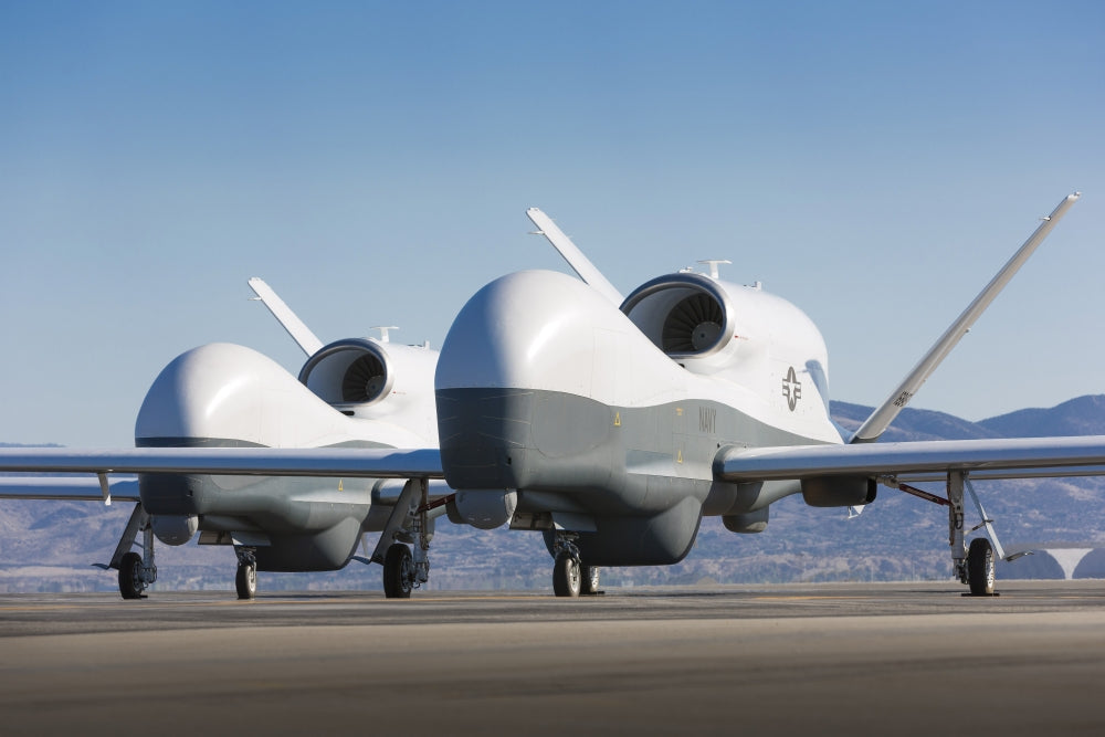 Two MQ-4C Triton unmanned aerial vehicles on the tarmac poster print.
