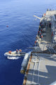 Sailors executing rescue operations in a rigid-hull inflatable boat poster print.