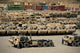 Rows of heavy vehicles and supplies at Camp Warrior, Afghanistan poster print.