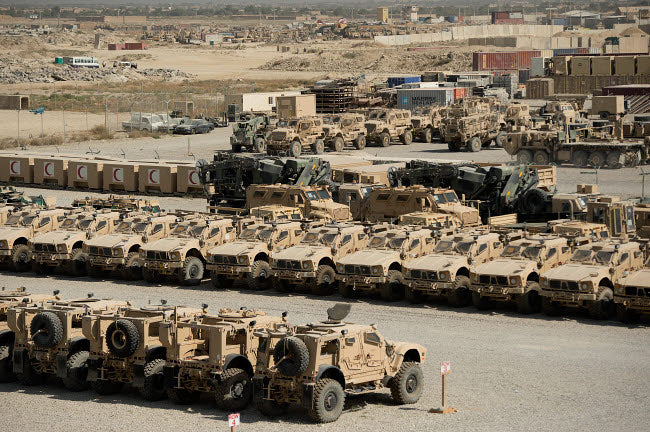 Rows of heavy vehicles and supplies at Camp Warrior poster print