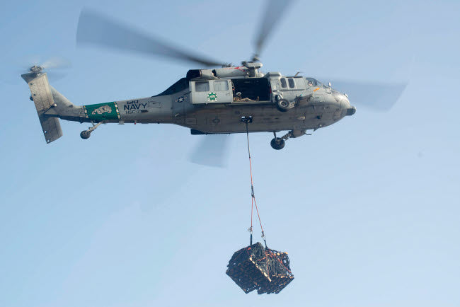 MH-60S Knighthawk delivering cargo poster print