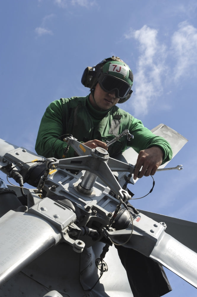 MH-60R Seahawk helicopter maintenance poster print on USS Nimitz.