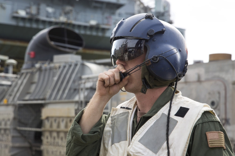 Operations Specialist radioing instructions on LCAC during naval operations.