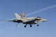 F/A-18C Hornet flying over USS Nimitz in the Mediterranean Sea poster print