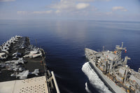 USNS Rainier transit next to USS Nimitz poster print showcasing naval vessels.