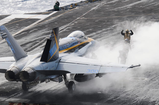 F/A-18C Hornet Launch Preparation Poster Print featuring sailors on USS Nimitz.