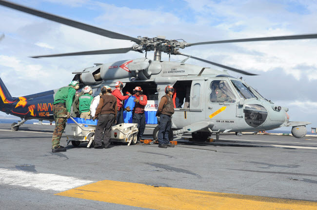 MH-60S Seahawk poster print featuring sailors loading fresh water.