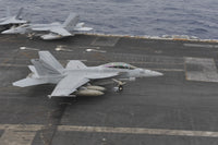 F/A-18F Super Hornet landing on USS Nimitz flight deck in South China Sea.