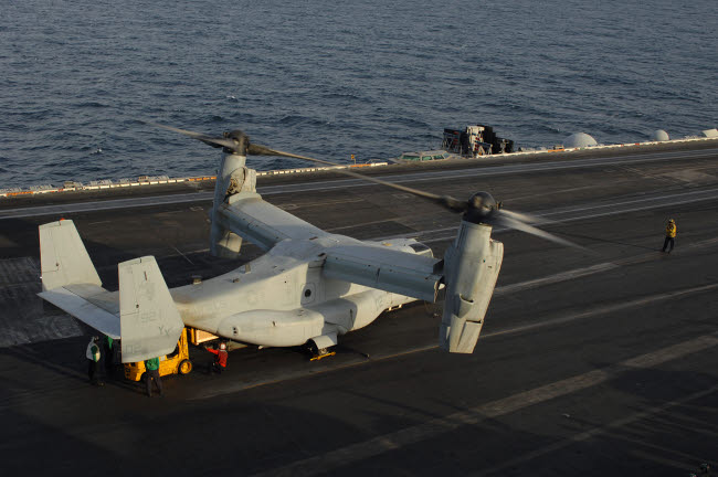 MV-22 Osprey receiving cargo on USS Harry S Truman poster print