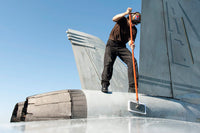 Airman washing an F/A-18F Super Hornet Poster Print by Stocktrek Images