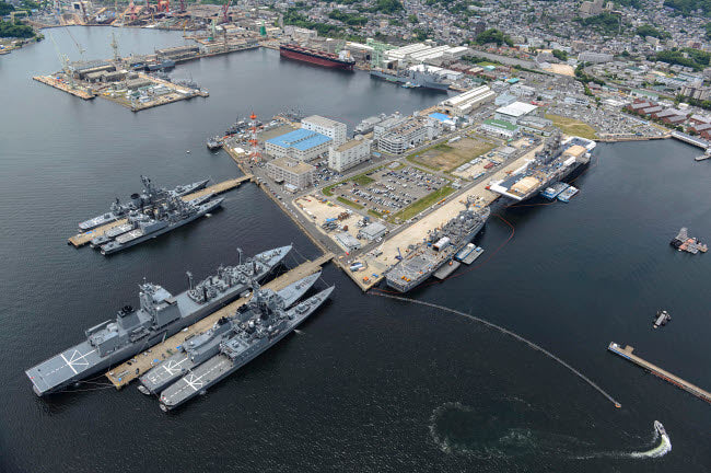 Aerial view of military ships moored at Sasebo, Japan poster print.