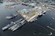 Aerial view of military ships moored at Sasebo, Japan poster print.